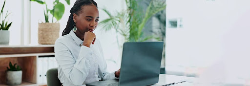 A woman at her computer examining Setuply's solution to case management