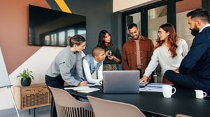 A young woman shares new client onboarding technology with her team