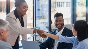 fintech clients shaking hands at conference table