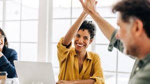 Two employees giving a high-five to illustrate Setuply success stories